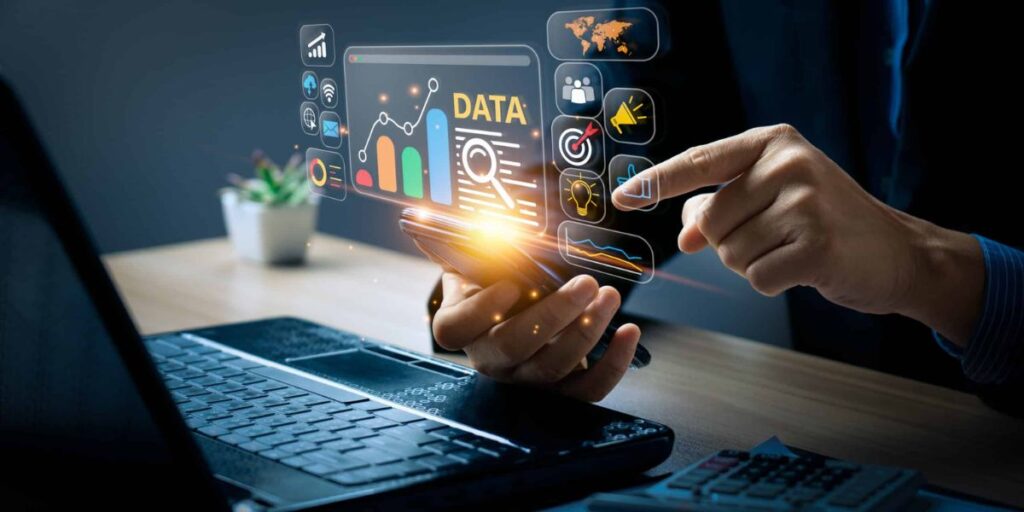 Hands holding a phone with an overlay of digital data and marketing icons.