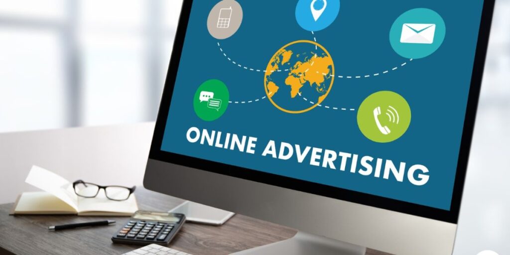 Computer monitor showing "Online Advertising" with digital icons surrounding a globe.